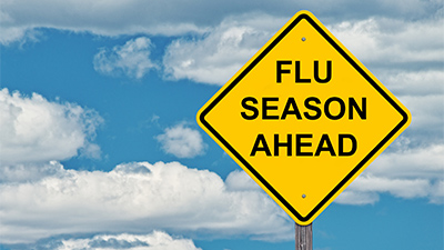 A road sign reading Flu Season Ahead