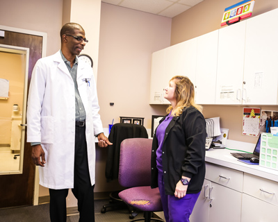 Two people discuss treatment options in a doctor office